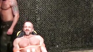 Muscly hunk restrained for rough and hardcore BDSM torment