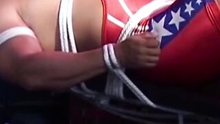 Hunk in uniform is tied up as he tries to release himself