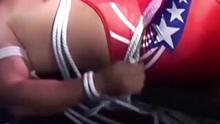 Hunk in uniform is tied up as he tries to release himself