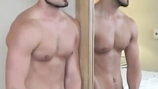 Stud sensual stroking of his hard cock in front of a mirror