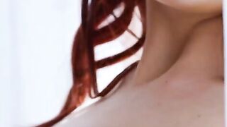 Stunning redhead Madelane caresses her lovely body through her silk lingerie