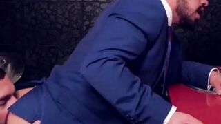 Two men in suits have sex in the toilet at work