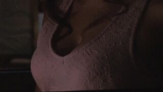 The breast of a woman with a smirk face inside
