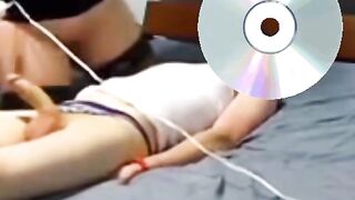 A woman is massaging Moisa Robert's dick with a vibrator.