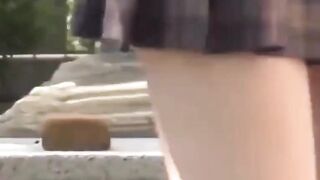 Sporty Japanese babe filmed playing in a tiny short skirt
