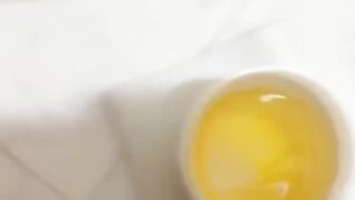 Witness a lovely lady fill a container with her warm urine