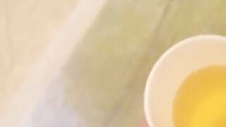 Japanese babes golden stream fills the container on camera