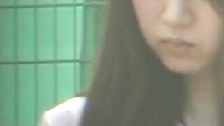 Uniformed girl rubs under her skirt and pees through panties