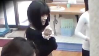 Voyeur films three petite Japanese spraying in a bathhouse