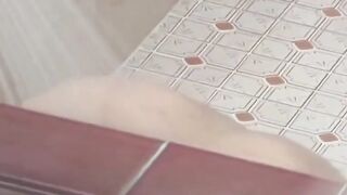 Voyeur films three petite Japanese spraying in a bathhouse