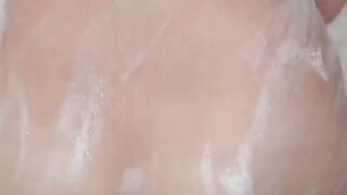 Voyeur films three petite Japanese spraying in a bathhouse