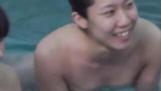 Voyeur films three petite Japanese spraying in a bathhouse