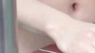 Voyeur films three petite Japanese spraying in a bathhouse