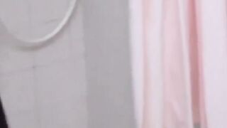 Voyeur films three petite Japanese spraying in a bathhouse