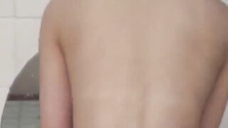 Voyeur films three petite Japanese spraying in a bathhouse
