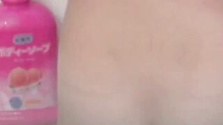 Voyeur films three petite Japanese spraying in a bathhouse
