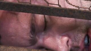 Helpless Colt Rivers trapped inside a cage while Adam Herst anal fucks him
