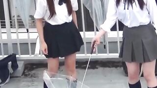Naughty schoolgirls collect golden showers with an umbrella