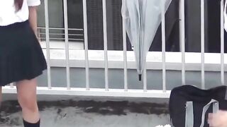 Naughty schoolgirls collect golden showers with an umbrella
