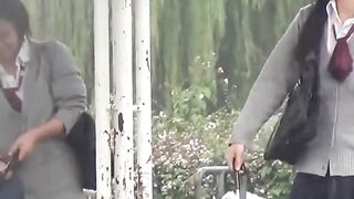 Naughty schoolgirls collect golden showers with an umbrella