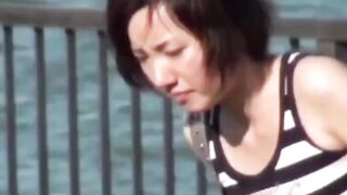 Voyeur films Asian women making puddles ina  public park