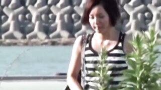 Voyeur films Asian women making puddles ina  public park
