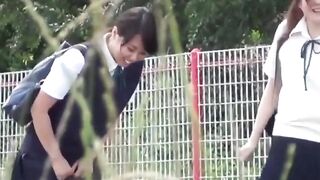 Japanese schoolgirl teens are teasing each other while peeing