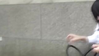 Adorable girl rushes to the park to find a spot to pee