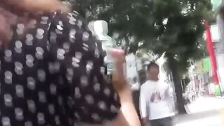 Cameraman hands her juice while she finds a spot to pee