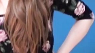 Asian amateur girl peeing in shorts during solo photoshoot