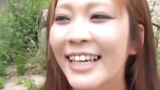 Lustful Japanese girl rubs her pussy around the park
