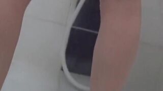 Petite Japanese girl rubs her pussy before warm peeing shower