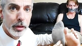 Professor Lennox tickles the feet of his student Jessie Russel through his stinky soc