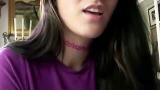 Brunette in Purple Top with Glasses Smiling at Camera
