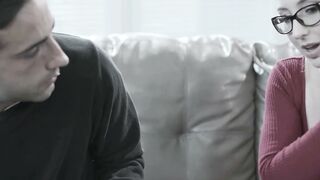 Glasses Girl in Red Top and Black Skirt Sits on Couch with Man
