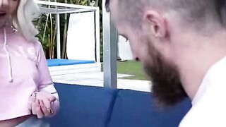 Blonde in Pink Hoodie Sits on Blue Patio Couch Outdoors