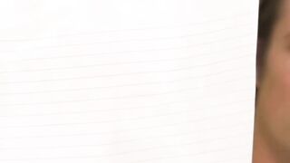 Blonde Teacher with Glasses Grades Papers in Classroom