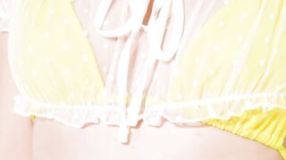 Blonde in Yellow Bikini Poses with Rubber Duck and Inflatable Toy