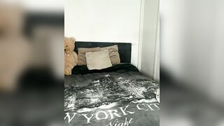 Busty Brunette in Black Bodysuit Teases on Bed