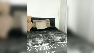 Busty Brunette in Black Bodysuit Teases on Bed