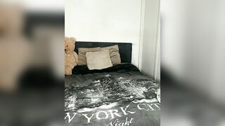 Busty Brunette in Black Bodysuit Teases on Bed