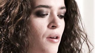 Brunette with Curly Hair in Sheer Black Top and Nude on Bed
