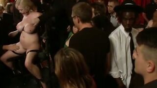 Blonde Woman Bound in Rope Harness at Candlelit Party with Vibrator Play