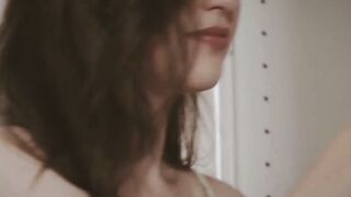 Brunette taking naked mirror selfie with vintage camera