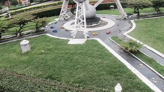 Brunette Woman in Striped Dress Walking Past David Statue