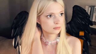 Blonde Angel Girl in Pink Corset Teases with Black Wings and Fishnets